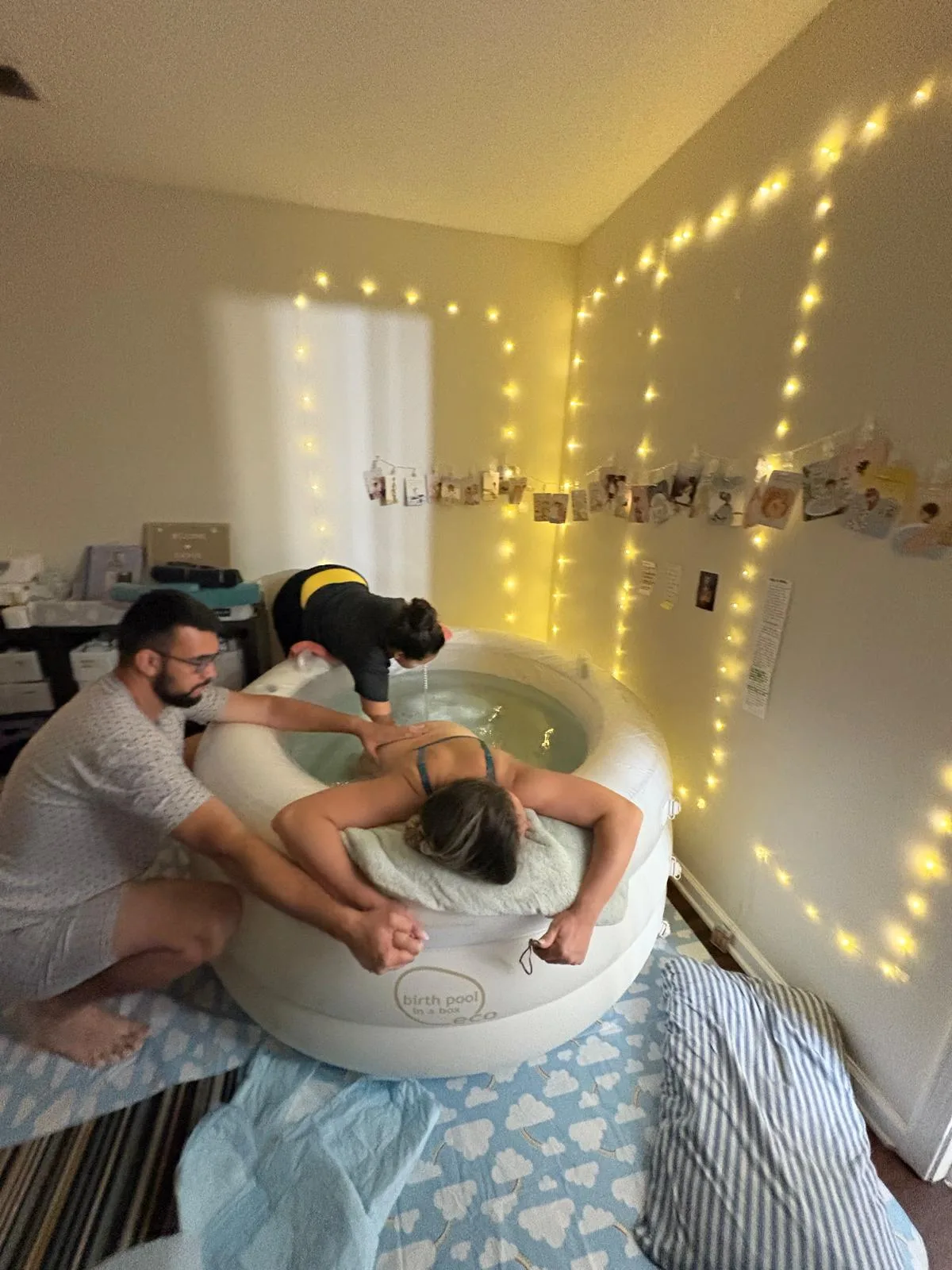 Partner and doula supporting a mother during a home water birth